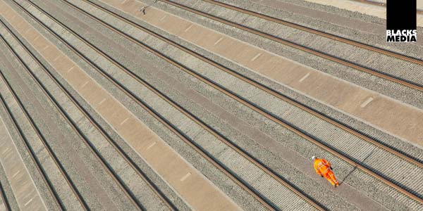 Rail photography Rail employee walking down rail track